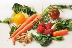A variety of healthy foods, including fruits, vegetables, nuts, and seeds, known to promote clear and glowing skin