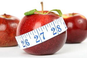 Tracking your progress with a measuring tape to monitor belly fat loss and health improvements.