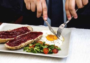 Grilled steak and fried eggs on a white plate