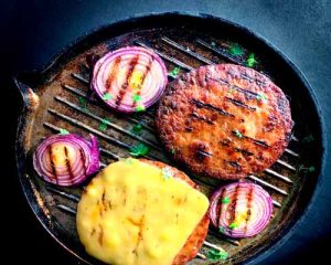 Grilled steak and poached eggs garnished with herbs, a gourmet breakfast delight.