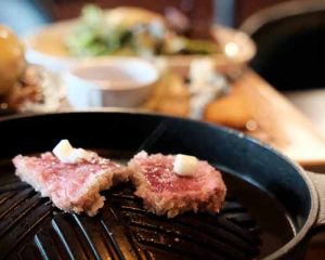 Sizzling sirloin steak paired with scrambled eggs, a hearty and nutritious dish.