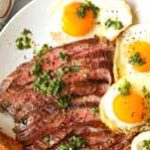 Lean grilled steak strips and scrambled eggs with a side of sautéed spinach for a healthy breakfast.