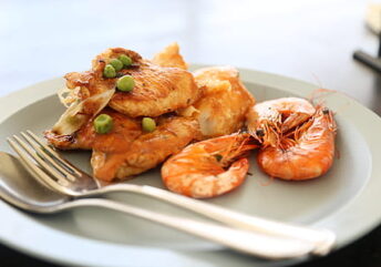 A plate featuring a variety of animal based meals—juicy chicken, succulent prawns, and tender fish fillets.