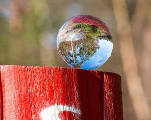 A clear crystal ball on a wooden stand, symbolizing insight into present indefinite tense examples rules.