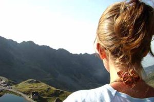 Losing weight on the steak and eggs diet while standing strong before a long mountain landscape.