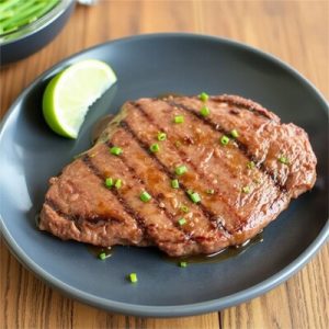 Juicy marinated flat iron steak grilled to perfection with fresh herbs and spices