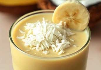 Creamy coconut banana recovery smoothie with protein powder, ideal for post-workout muscle repair.