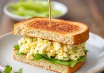 Egg salad sandwich with soft bread — a creamy, braces-friendly meal perfect for pairing with soup.