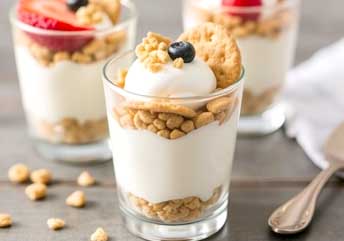 Mini yogurt and graham cracker parfaits — a soft, braces-friendly dessert layered with creamy yogurt and tender crumbs.
