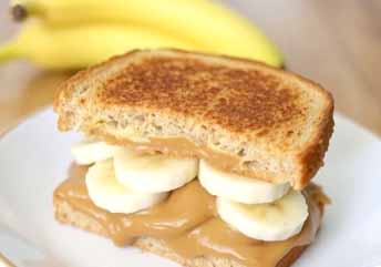Peanut butter and banana sandwich on soft bread — a creamy, braces-friendly snack or soup side.