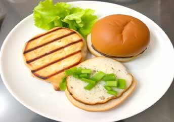 Soft grilled chicken and halved burger — a braces-friendly protein-packed lunch served on a plate. what foods can you eat with braces