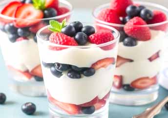 Yogurt and berry parfaits — creamy, braces-friendly layers of smooth yogurt and soft berries in a glass.