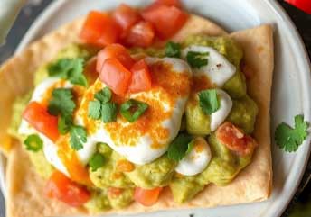 Soft pita “nachos” topped with creamy guacamole — a gentle, braces-friendly snack or soup side dish.