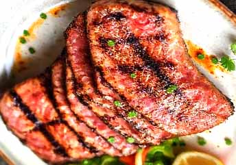 Grilled ahi tuna steak recipe — juicy, smoky, and simple tuna fillet with charred grill marks, served with fresh garnish.