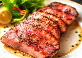 Pan-seared ahi tuna steak recipe — restaurant-style seared tuna with sesame crust, sliced and served with dipping sauce.