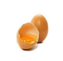 Liquid egg whites pouring into a half cup measure for high protein breakfast prep.