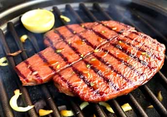 A keto-friendly steak and eggs carnivore diet meal served on a ceramic plate.