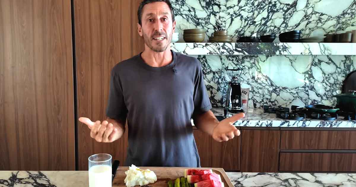 Dr. Paul Saladino, widely known as Carnivore MD, holding an animal-based meal featuring grass-fed beef steak, organ meats, and fresh fruit.